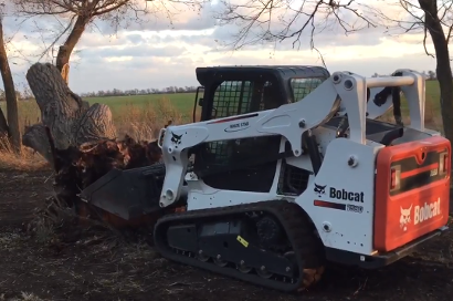 A thumbnail of Hennes Excavating removing a dead tree stump.